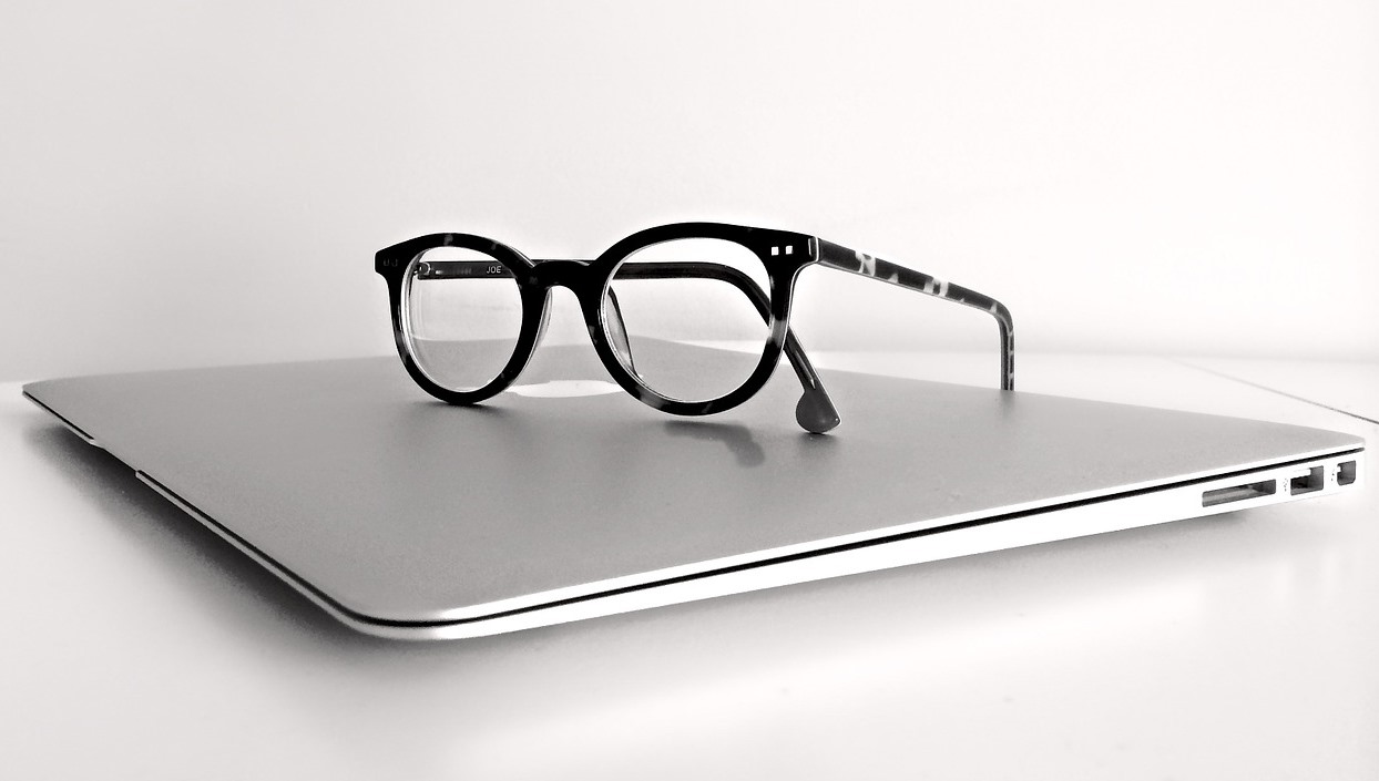 Reading eyeglass on top of the laptop